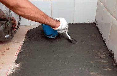 Applying waterproofing material to floor
