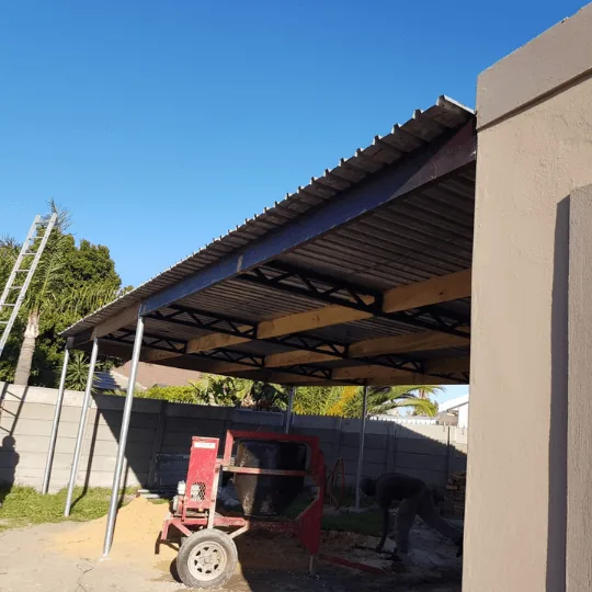 Construction site with metal roof structure and equipment