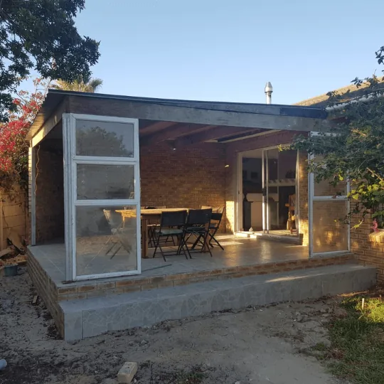 Elegant patio with tiled floor and glass enclosure