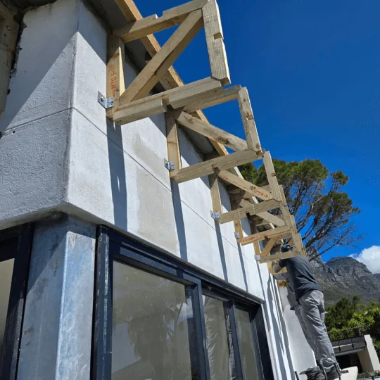 Installing wooden trusses on building exterior