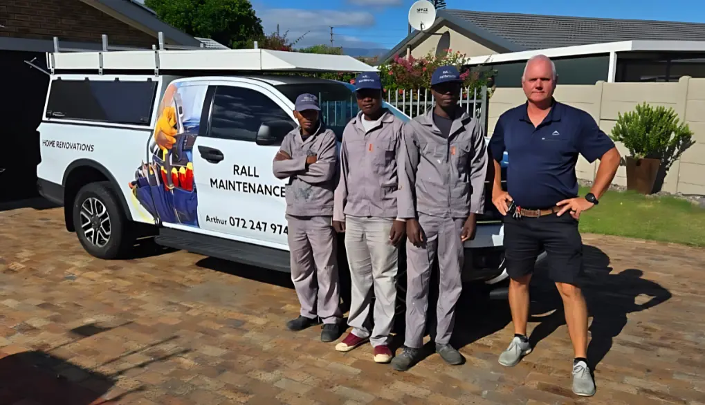 Team one standing in front of home renovation service vehicle
