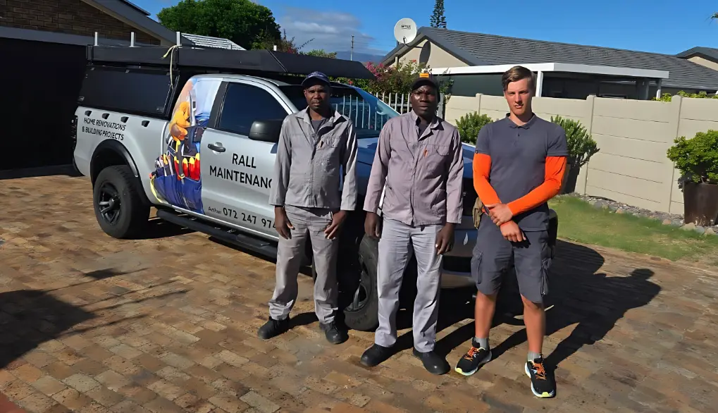 Team three standing in front of home renovation service vehicle