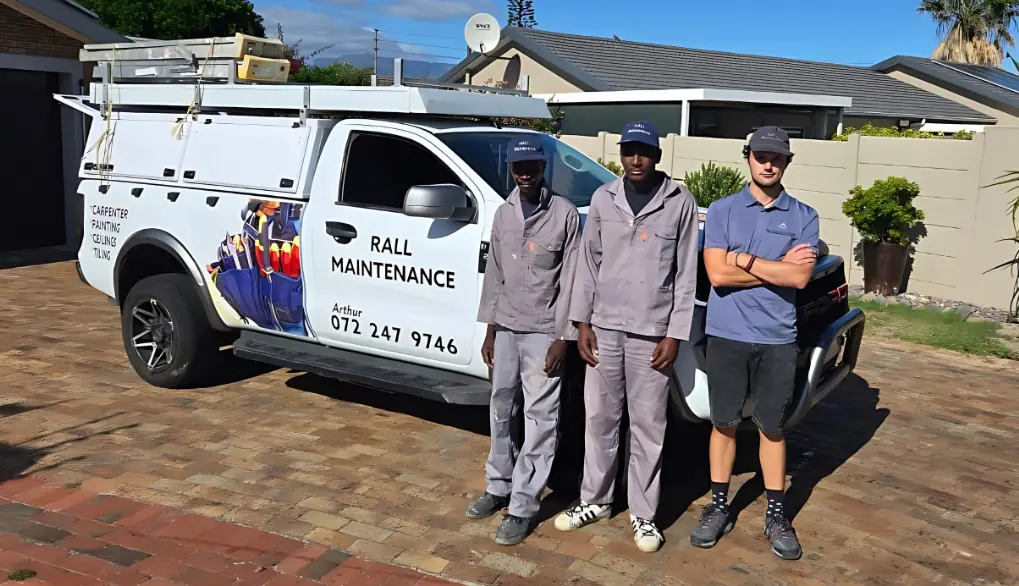 Team two standing in front of home renovation service vehicle