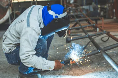 Welding metal pipes in an industrial setting