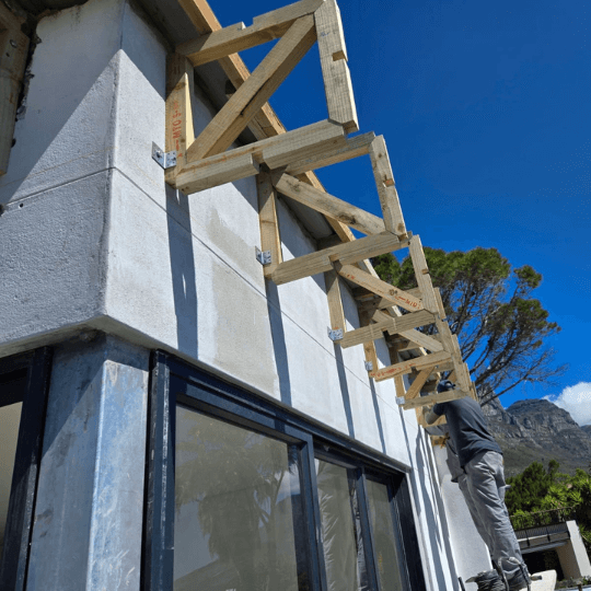 Installing-Wooden-Trusses-on-Building-Exterior-1-1-1.png